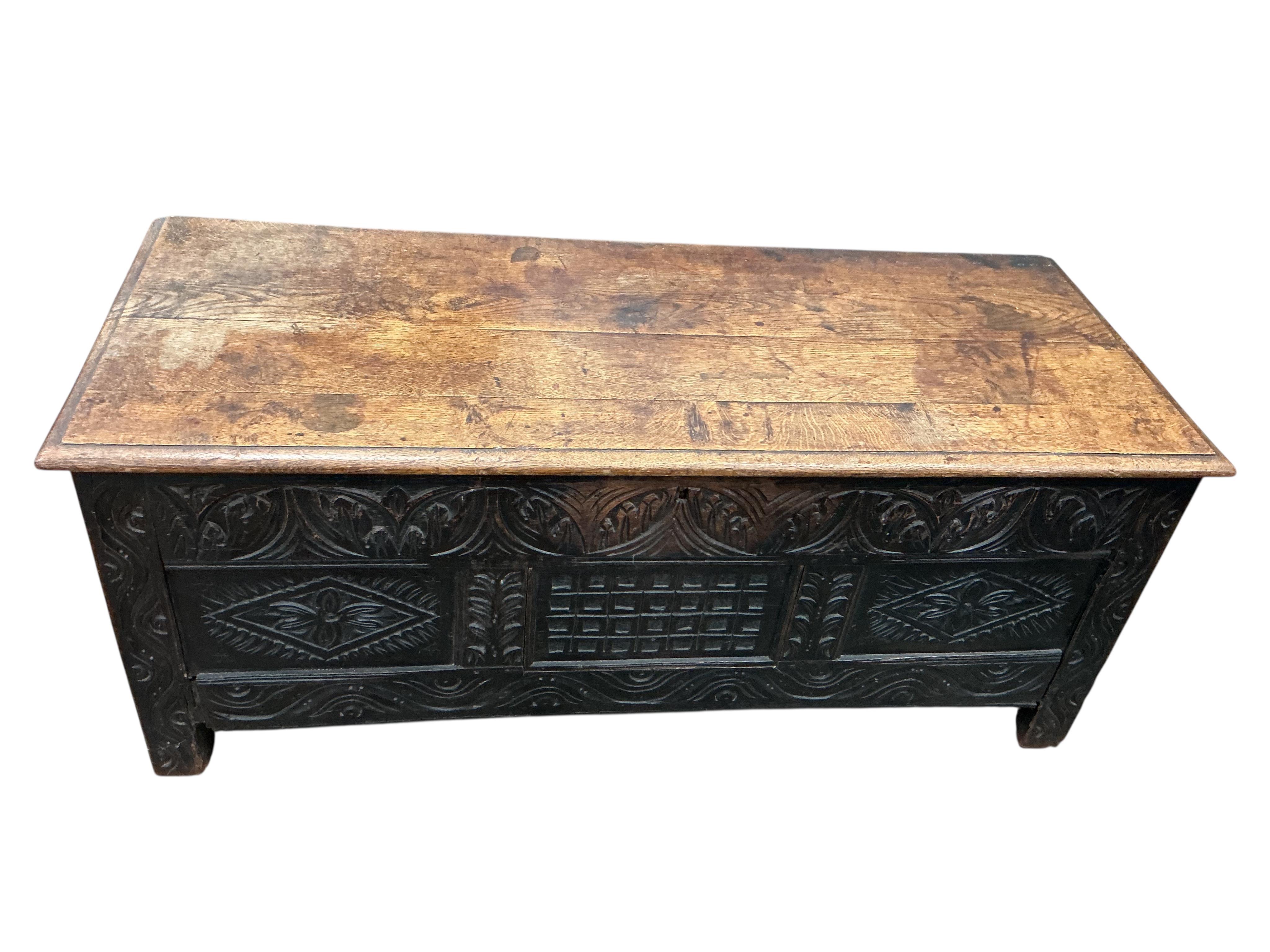 An 18th century panelled oak coffer, width 136cm, depth 54cm, height 56cm
